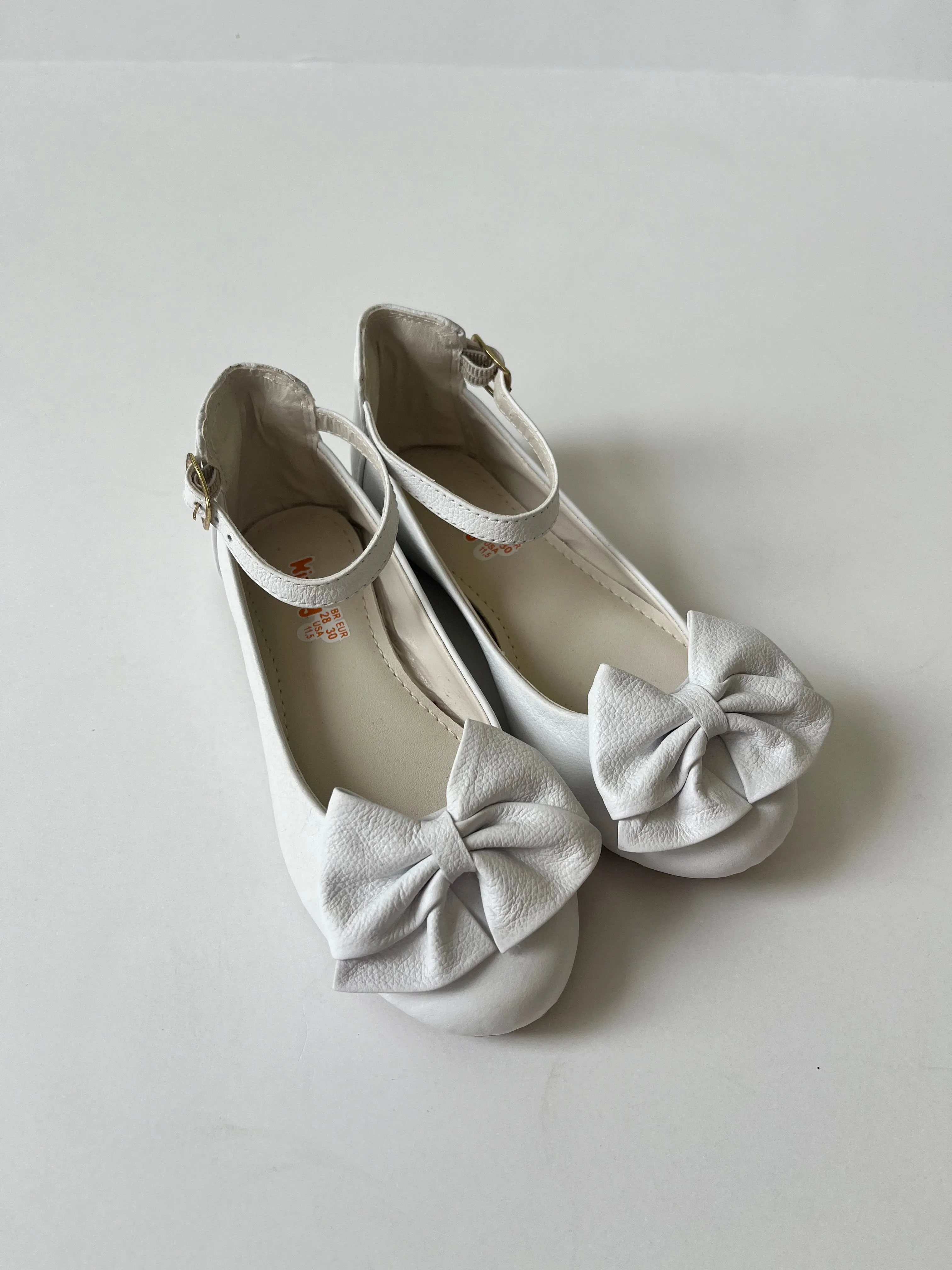 White ballet flat with ankle strap